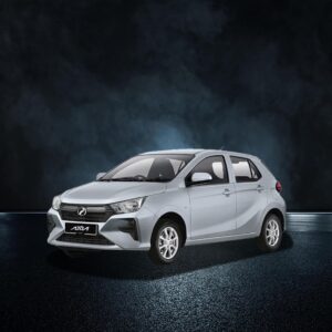 Silver Perodua Axia hatchback in studio with dark background, front-side view.